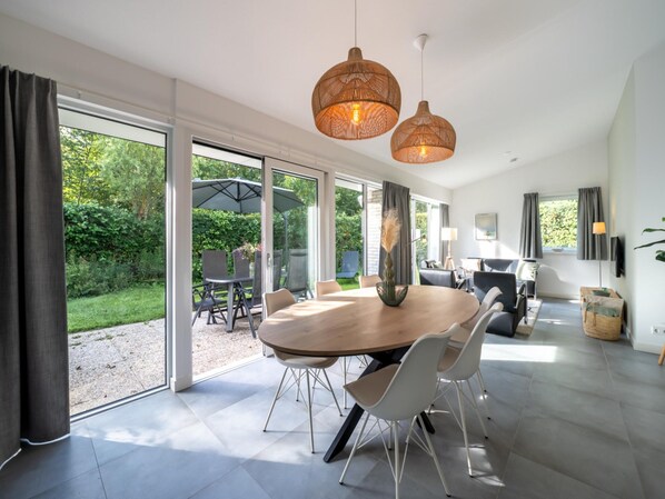 Enjoy meals in this dining area with a large round table and comfortable seating for all.