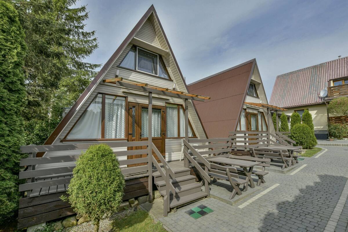 A row of triangular-shaped cabins with wooden railings and steps leading to the entrance.