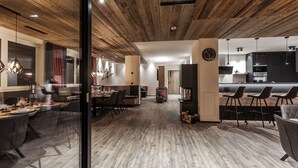 A modern interior with a dining area, kitchen, and seating space. - Graceful Chalet in Gaschurn With Sauna (Gaschurn)