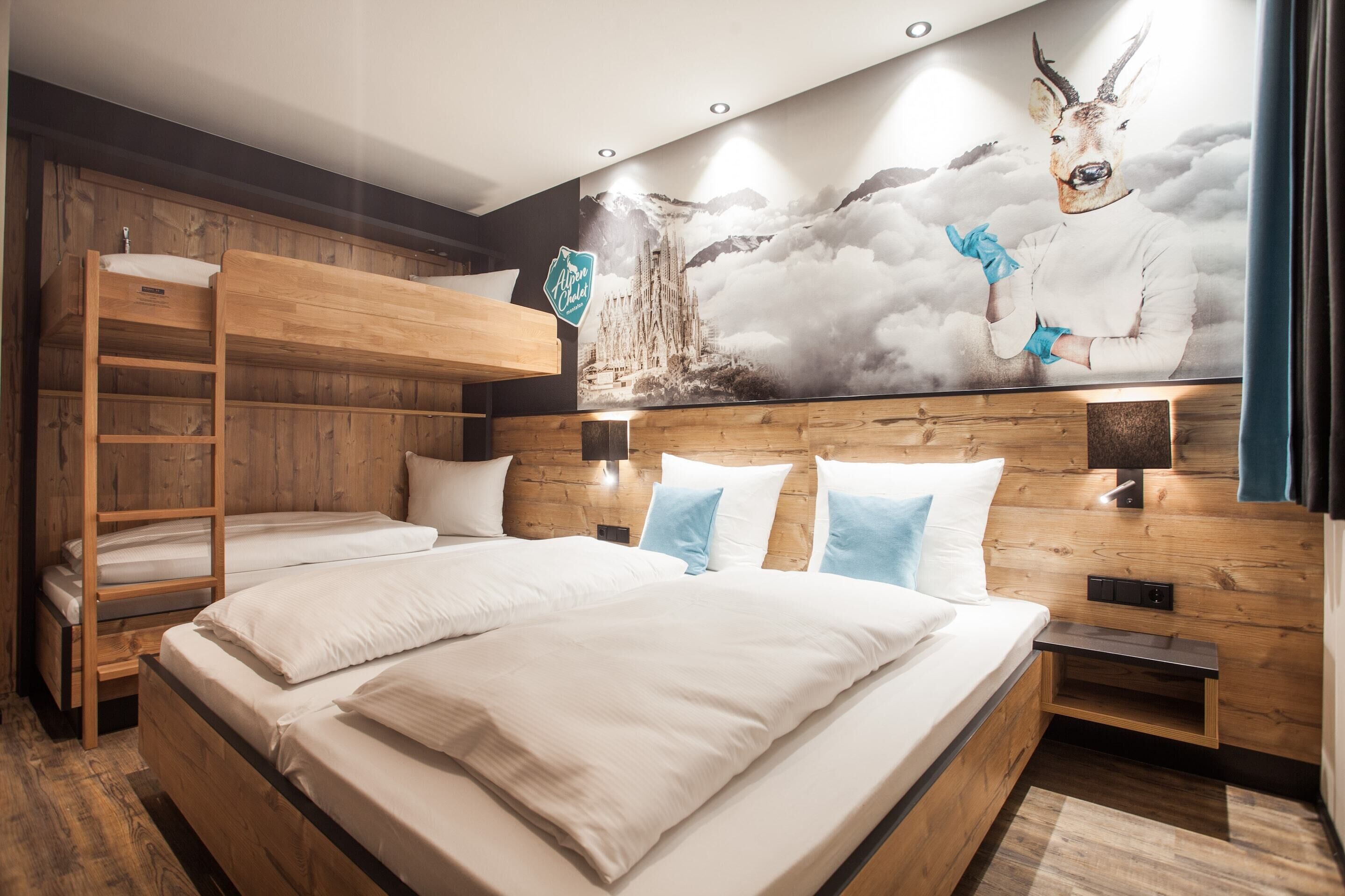 A bedroom with bunk beds, a wooden headboard, a mural, and a nightstand.