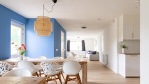 A modern living space with a dining area, kitchen, and seating area. - Lovely Apartment on Ameland Near Nes (Nes)