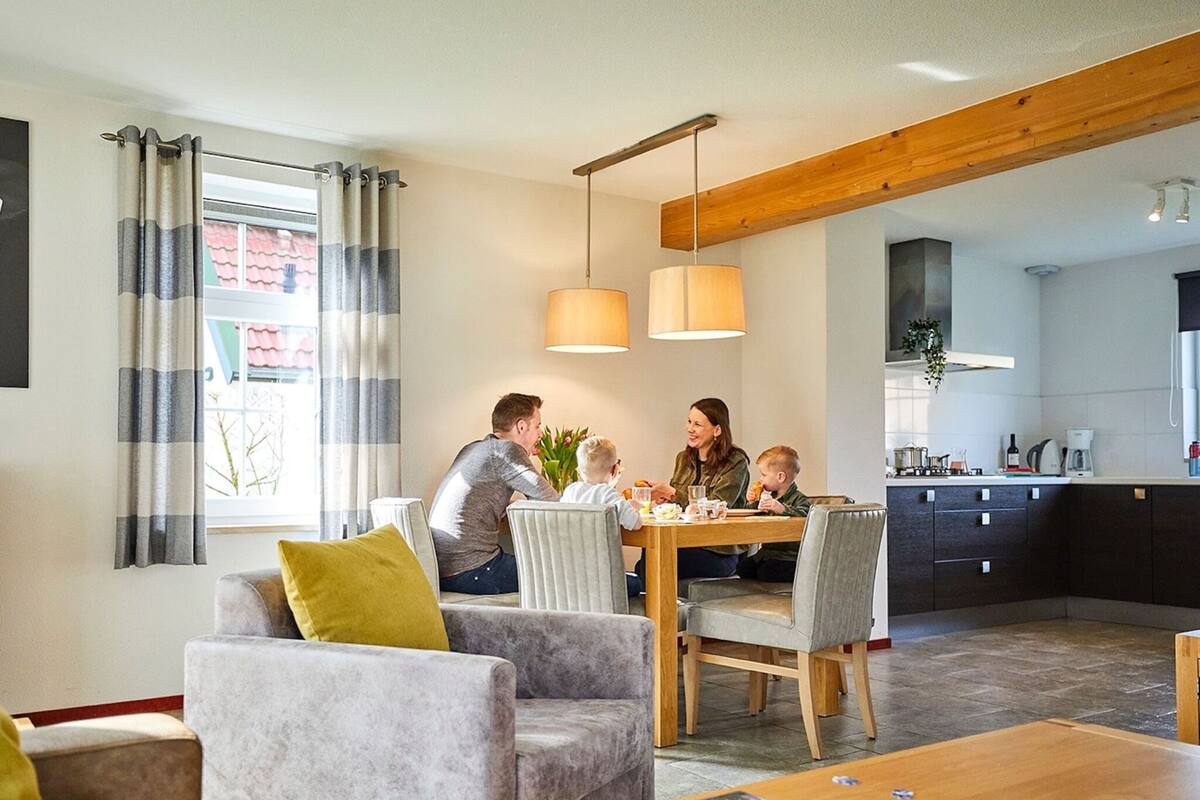 A modern living room with a dining table, sofas, and a coffee table with puzzle pieces.