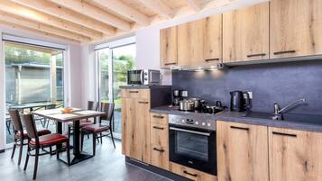 Deluxe Bungalow, 2 Bedrooms | Private kitchen | Fridge, microwave, oven, dishwasher