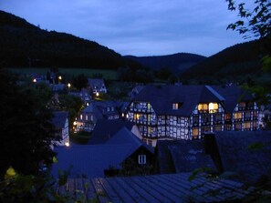 A traditional European village at dusk with timber-framed houses and a small church. - Apartment in Schmallenberg-oberkirchen With Terrace (Schmallenberg)