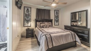 A bedroom with a bed, nightstands, a dresser, a ceiling fan, and artwork on the walls. - Lady Luck Lodge -Mountain View-Fire Pit-Open Covered Porch-Wifi (Whittier)