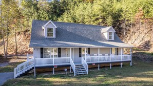 A two-story house with a porch, a staircase, and a small deck. - Lady Luck Lodge -Mountain View-Fire Pit-Open Covered Porch-Wifi (Whittier)