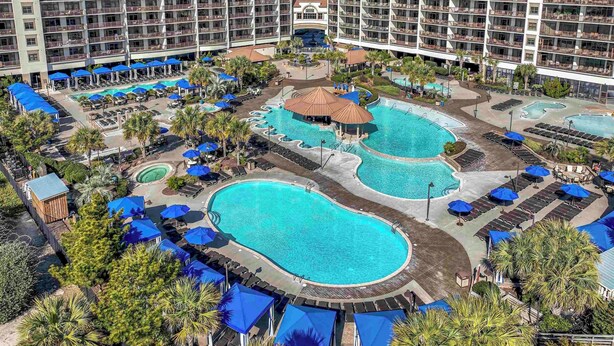 A hotel with multiple swimming pools, sun loungers, and umbrellas. - 🌊Oceanfront~Lazy River~Awesome Amenities~ North Beach Resort 210🌊 (North Myrtle Beach)