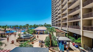 A resort with a pool area, palm trees, and a multi-story building with balconies. - 🌊Oceanfront~Lazy River~Awesome Amenities~ North Beach Resort 210🌊 (North Myrtle Beach)