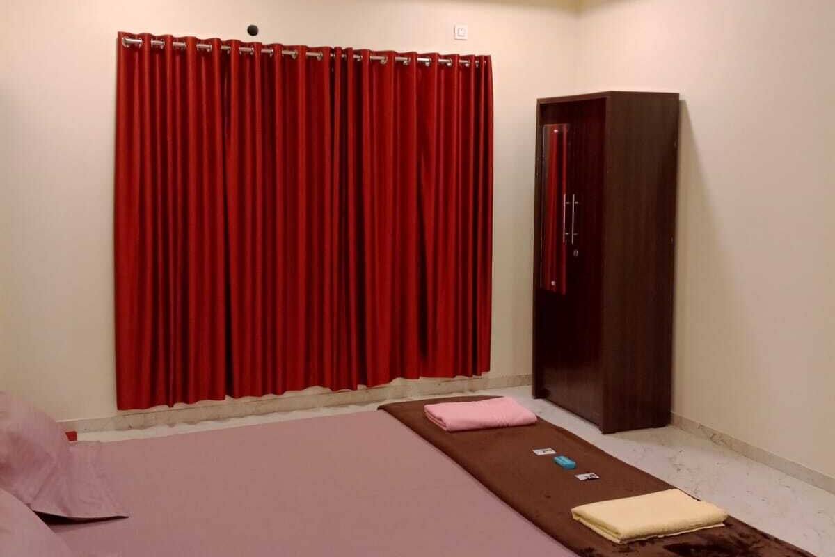 A bedroom with a bed, a wardrobe, and a ceiling fan.