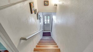 A wooden staircase with white walls and a door at the top. - Pet-friendly Studio in Costa Mesa - 7 Mi to Beach! (Costa Mesa)