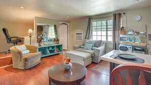 A living room with two sofas, a coffee table, a dining table, and a kitchen area with appliances. - Pet-friendly Studio in Costa Mesa - 7 Mi to Beach! (Costa Mesa)