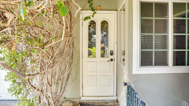 A white door with a glass panel, a window with blinds, and a porch with a railing. - Pet-friendly Studio in Costa Mesa - 7 Mi to Beach! (Costa Mesa)