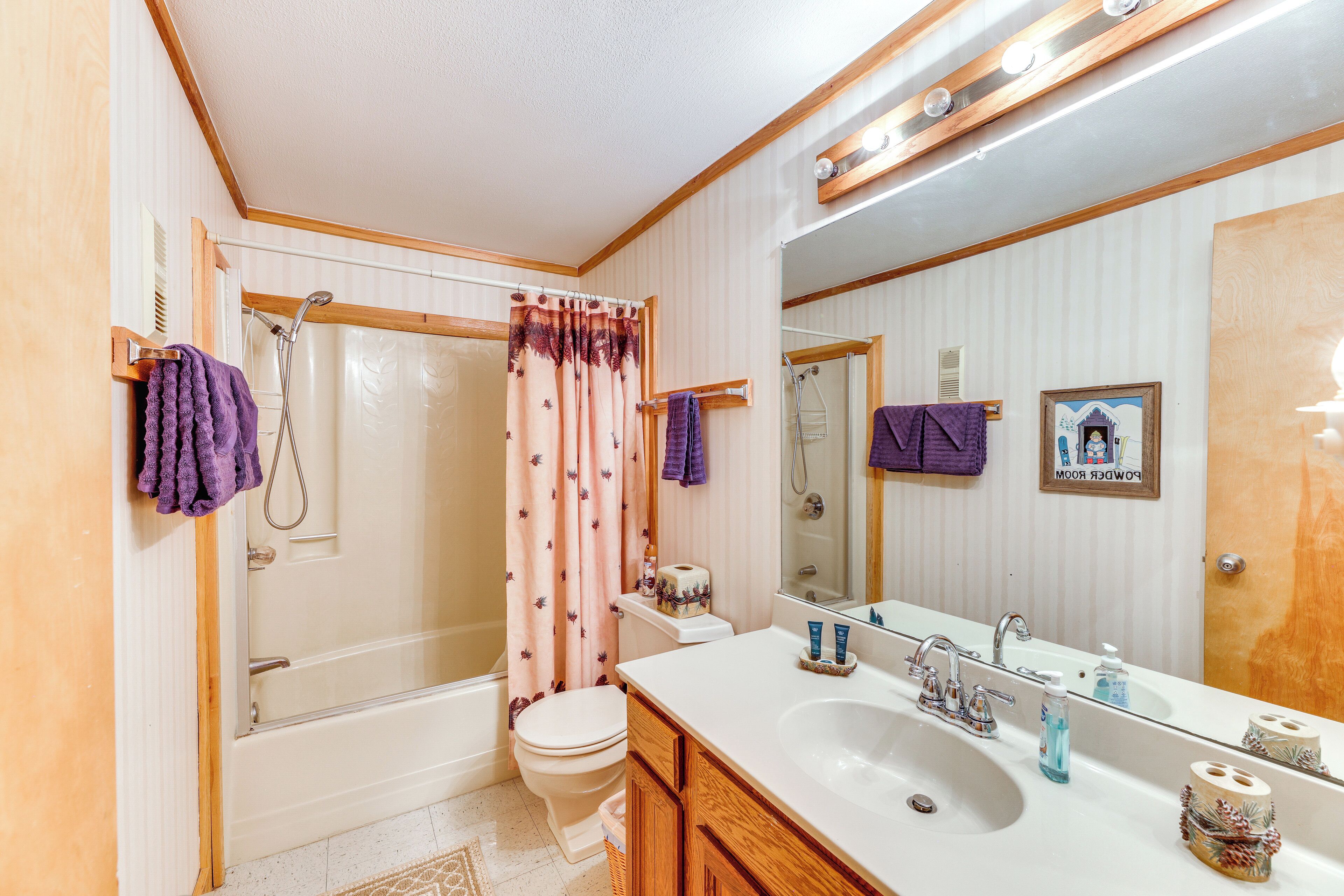 A bathroom with a bathtub, toilet, and sink.