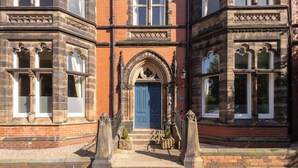 A historic building with a prominent blue door, stone facade, and symmetrical windows. - Host & Stay | Chatsworth Townhouse I (Carlisle)