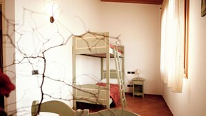 A bunk bed room with a ladder, a small bedside table, and a chair. - APARTMENT A FEW KILOMETERS FROM THE BEACH (Sala)