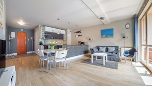 En moderne lejlighed med spiseplads, køkken og opholdsstue.