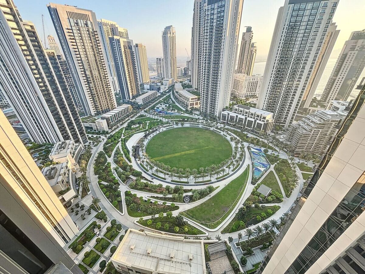 A high-rise building complex with a central circular park surrounded by residential towers.
