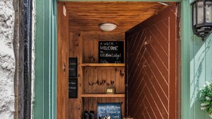A wooden door with a sign reading "Welcome to Cabin Lodge."