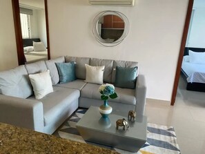 Relax in this stylish living room with a comfortable sofa, coffee table, and a beautiful rug.