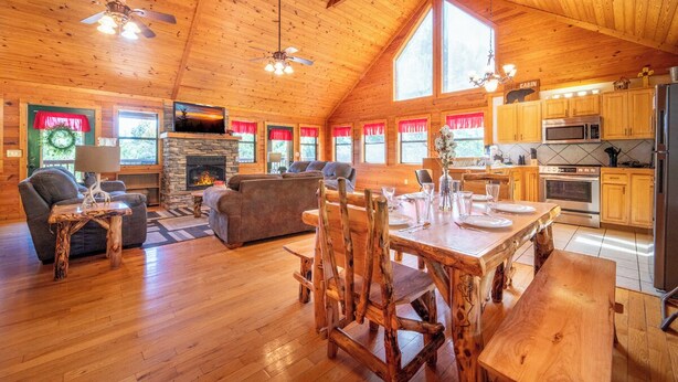 A spacious cabin interior with a dining area, living room, and kitchen.