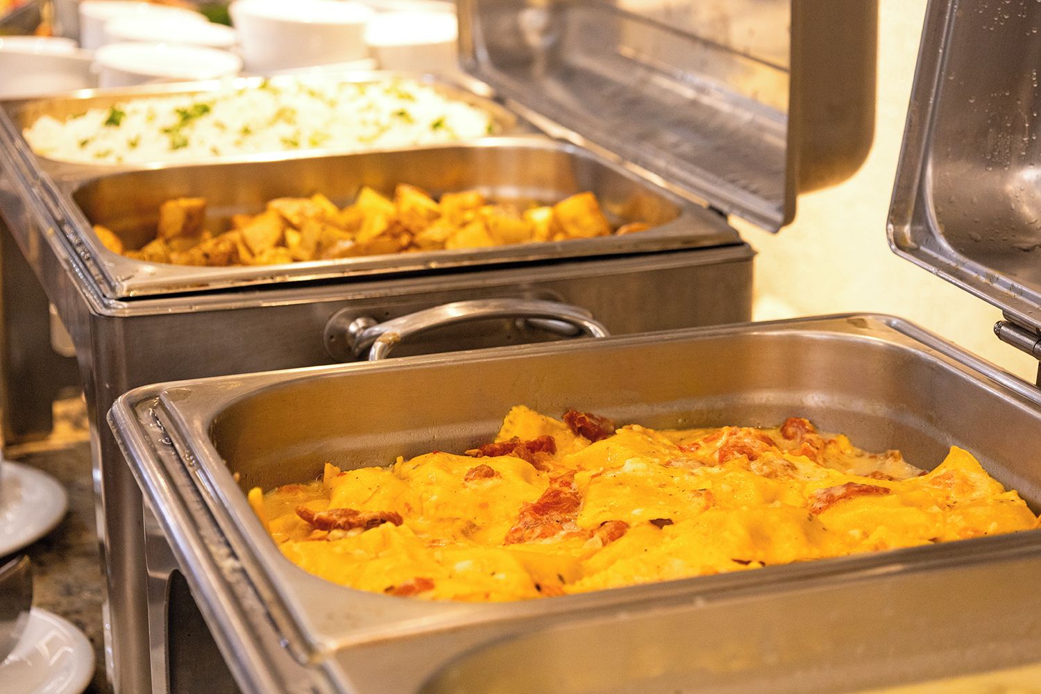 Ein Buffet mit verschiedenen Speisen in Metalltabletts.