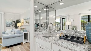 A modern kitchen with a large island, stainless steel appliances, and a marble countertop. - Seaside Beach & Racquet Club 5214 (Orange Beach)