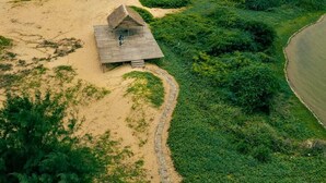 A beach with a wooden hut and a path leading to it. - The Alampara resort (Cheyyur)