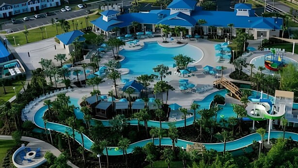 A resort with multiple swimming pools, a water slide, and a bridge connecting different areas. - Modern Paradise on Windsor Cay: Luxurious 8BD Home (Clermont)