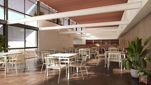 A spacious indoor dining area with white tables and chairs, large windows, and a modern ceiling design. - Hotel SunClub CalaVinya (Salou)