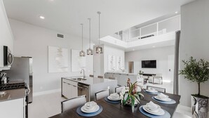A modern kitchen with a dining area. - 226 Spectrum new Loft 12 guests 5BDRS 15min Disney (Kissimmee)