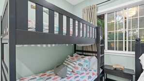 A bunk bed with a headboard, a bedside table, and a window with curtains. - Oceanview home walking distance to beach, pier & short drive to downtown Ventura (Ventura)