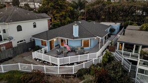 A two-story house with a covered patio, a flag, and a fenced deck. - Oceanview home walking distance to beach, pier & short drive to downtown Ventura (Ventura)