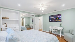 A bedroom with a bed, a desk, a chair, a ceiling fan, and a wall-mounted TV. - Oceanview home walking distance to beach, pier & short drive to downtown Ventura (Ventura)