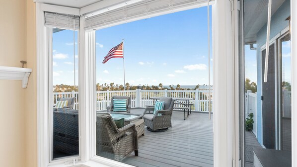 A covered outdoor deck with wicker furniture and a view of the ocean. - Oceanview home walking distance to beach, pier & short drive to downtown Ventura (Ventura)