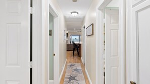 A hallway with white doors, a wooden floor, and a starfish-patterned rug. - Oceanview home walking distance to beach, pier & short drive to downtown Ventura (Ventura)