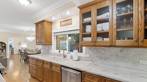 A kitchen with wooden cabinets, a marble countertop, and a dishwasher. - Oceanview home walking distance to beach, pier & short drive to downtown Ventura (Ventura)