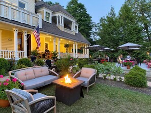 An outdoor patio with a fire pit, seating, and umbrellas. - The Millerton Inn (Millerton)