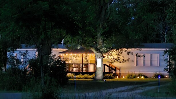 A house with a porch, a small fence, and a driveway. - Thoughtfully Renovated 2BR Retreat|10 Miles to South Haven & Lake Michigan (Bangor)