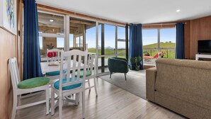 A spacious living area with a large window offering a view of the outdoors.