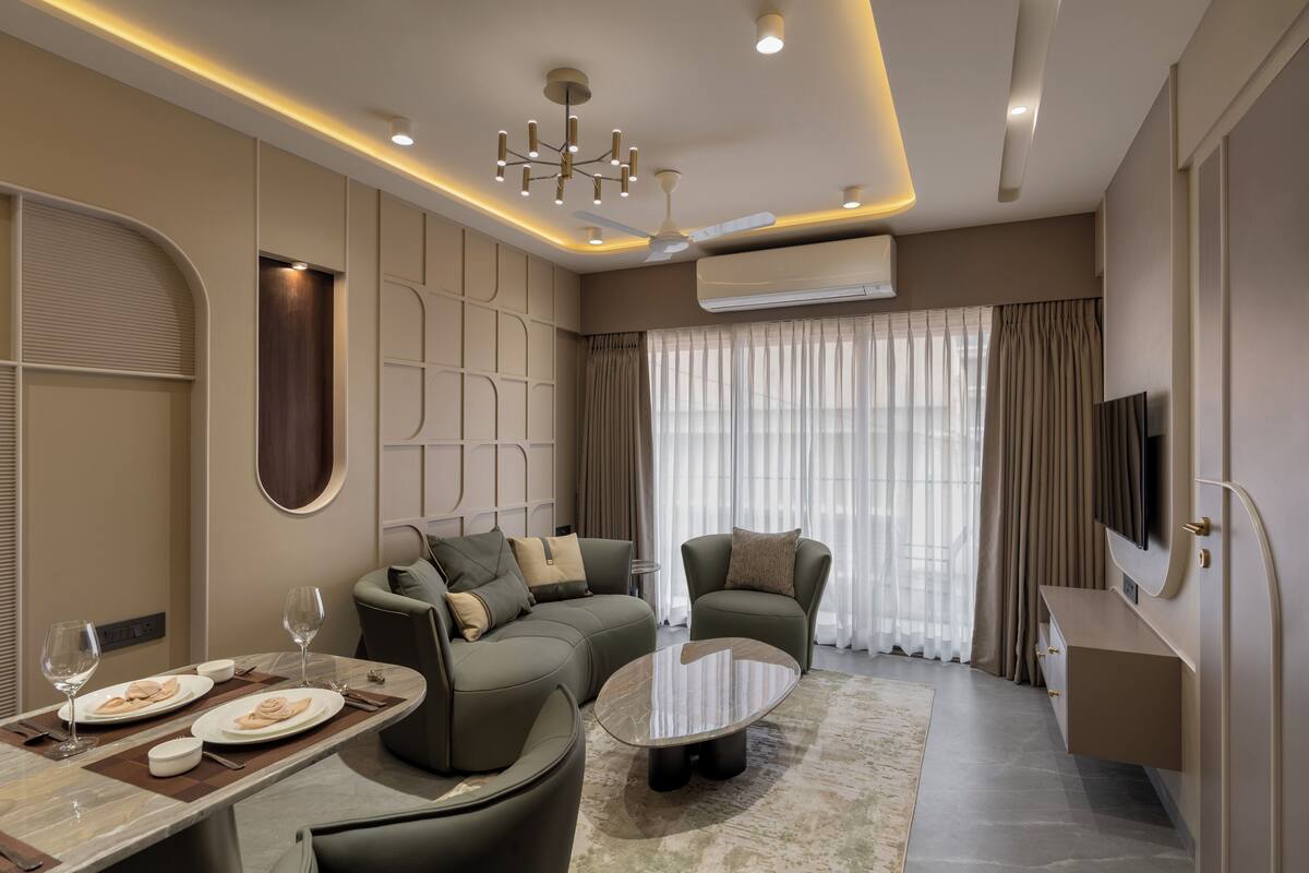 A modern living room with a sectional sofa, a coffee table, and a dining area with a set table.