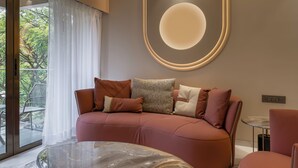 Un salon moderne avec un canapé, une table basse en verre et un ventilateur de plafond.