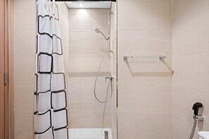A modern bathroom with a shower, toilet, and a towel rack. - Silkhaus Farhad Azizi (Dubai)
