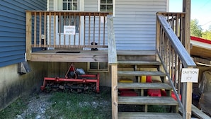 A wooden deck with a 'Caution Icy' sign, a 'Beware of Dog' sign, and a 'Beware of Children' sign. - Cozy B&B in walking distance to onsite tasting room in Lee! (Lee)