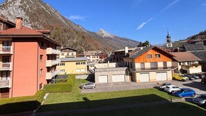 A residential area with houses, a mountain, and a clear sky.