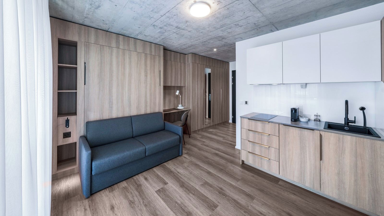A modern kitchen with wooden cabinets and a built-in sink.