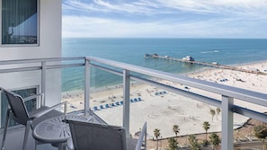 A balcony with a view of a beach, a pier, and a clear sky. - Soak Up the Sunshine at Wyndham Clearwater Beach-1 Bedroom Deluxe (Clearwater)