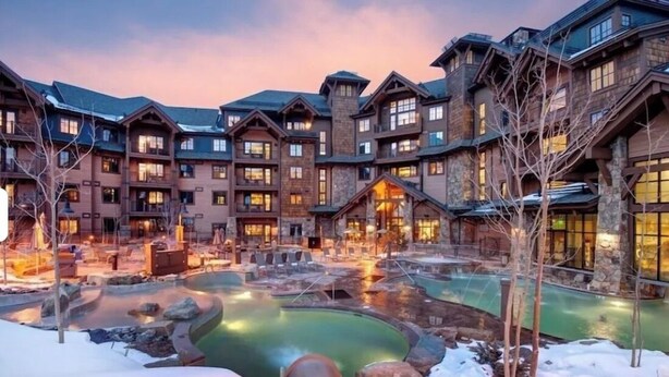 A resort with multiple buildings, a central pool area, and a snowy landscape. - Grand Lodge Peak 7: True Ski-in Ski-out resort Jan 10-17,2026  Breckenridge, CO  (Breckenridge)