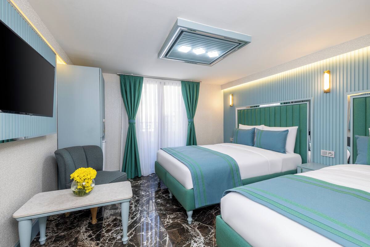 Deluxe Triple Room, City View | In-room safe, laptop workspace, blackout curtains, free WiFi