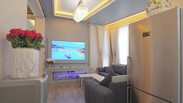 Design Apartment | Living area | 90-inch LED TV with satellite channels, iPad, video-game console