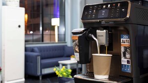 A coffee machine with a cup of coffee being dispensed, a sign indicating '20x LatteGo', and a 'Silent Brew' feature. - Santa Rio Gold Taxim (Istanbul)
